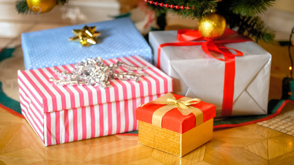 Fototapeta na wymiar Photo of heap of presents and gift boxes lying under Christmas tree