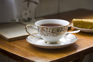 A cup of tea with red apples and cinnamon