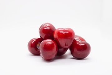 pile of cherries on white