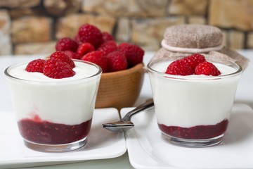 Fresh summer sweet snack. White yogurt, raspberries and raspberry jam combined into healthy organic parfait snack