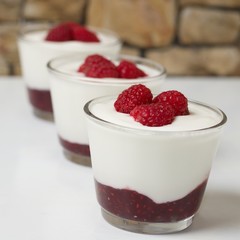 Three cups of simple fresh yogurt or skyr and raspberries parfait