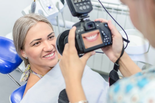 Dentist taking picture of smilling patient
