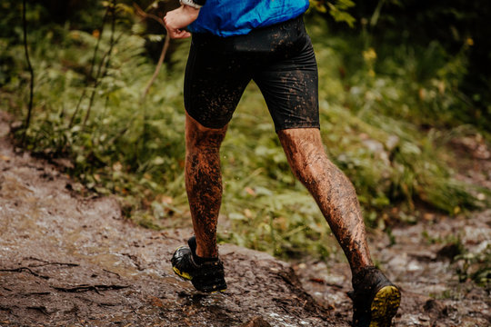 Back Man Runner In Mud Running On Autumn Trail In Forest