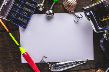 Frame for text on the background of fishing tackle, fishing rod and hooks. Fishing gear, copy space
