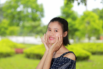 the face of young woman in bright background