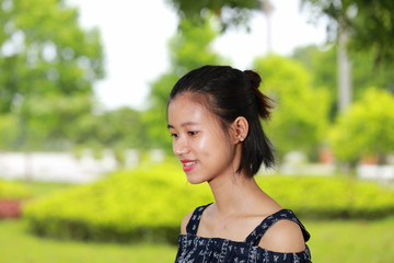 the face of young woman in bright background