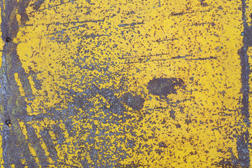 Worn yellow paint on metal sheet texture background