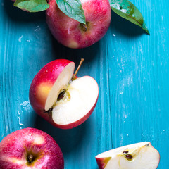 group of juicy apples lies on a wooden background