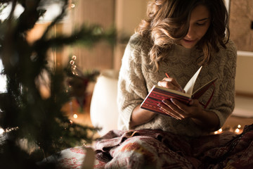 Woman writing on sketchbook