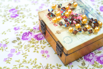 Vintage beads crystals and pearls with box and textile background
