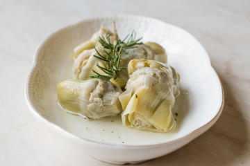 Pickled Artichoke Hearts with Rosemary Marinated in Plate.