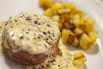 Fillet Steak with green pepper served with baked potatoes