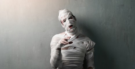Terrorific mummy on textured wall background.  Halloween holidays