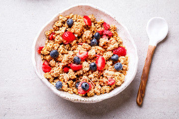 Granola Cereal bar with Strawberries and blueberries on the Background . Muesli Breakfast. Healthy Food sweet dessert snack. Diet Nutrition Concept. Vegetarian food. Flat Lay.Copy space
