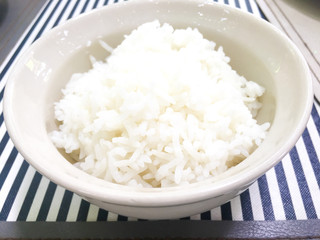 Cooked Rice in a bowl on dish white background