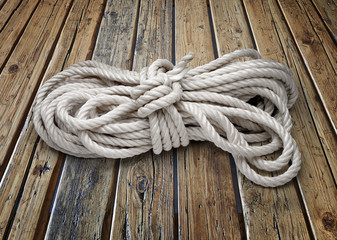 Close-up of twisted rope on wooden textured table