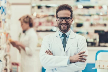 Fotobehang Portrait Smiling Pharmacist Working in Drugstore © VadimGuzhva
