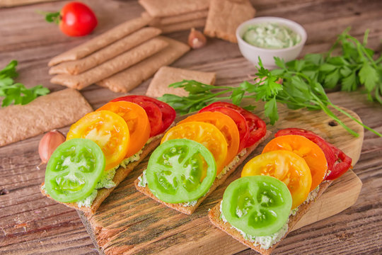 Toasts with cottage cheese, colorful tomato and greens