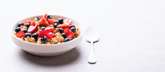 Granola Cereal bar with Strawberries and blueberries  on the Gray Background . Muesli l Breakfast. Healthy Food sweet dessert snack. Diet Nutrition Concept. Vegetarian food.Copy space  Banner.
