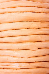 Close up of unglazed coiled pottery pot made of red clay