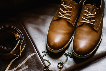 Closeup of elegant stylish brown male shoes. Preparation for wed