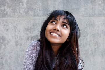 Close up young Indian woman smiling and looking up
