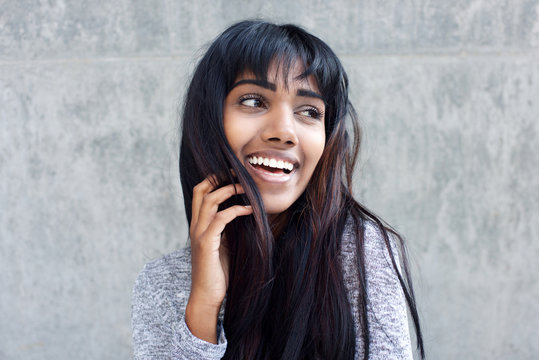 Young Indian Woman Laughing With Hand In Hair