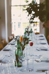 gorgeous white wedding banquet with table with wine glasses flowers and plants
