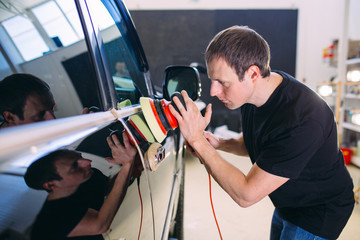 Polishing the car body.