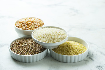 Assorted grains in the white bowls
