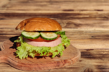 Fresh delicious homemade burger on wooden table