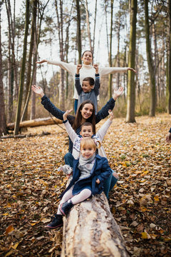 Brothers and sister kids playing in autumn park
