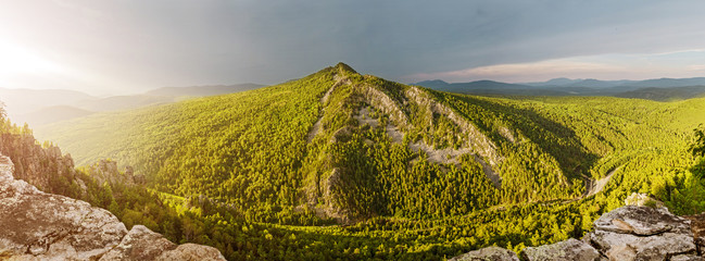 Panoramic view of a mountain peak covered by forest - Powered by Adobe