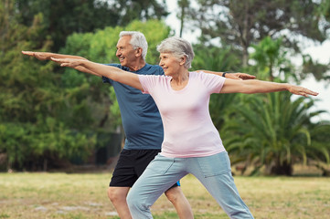 Old man and woman doing stretching exercise