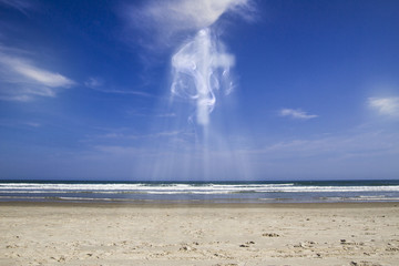 Blue sky in sunny day with clouds forming a large cross surrounded by lots of light and smoke, illustration with image montages