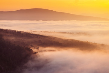 Colorful landscape in mountains with fog and sun