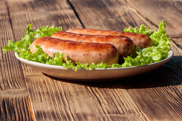 Grilled sausages on wooden table