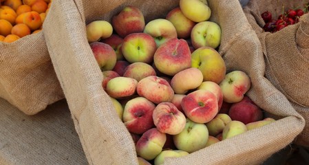 box of fresh saturn peaches
