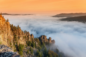 Rocks cliff with fog in mountains