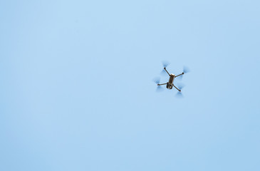 Black Drone flying in the blue sky