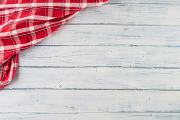 Top of view red checkered tablecloth on wooden table