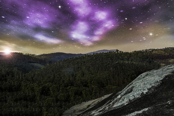 View from the top of a mountain with starry sky and a beautiful sunset, illustration with photo montage