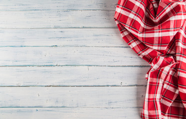 Top of view red checkered tablecloth on wooden table