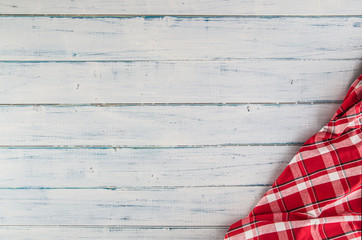 Top of view red checkered tablecloth on wooden table