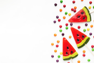 Sweet summer background, waretmelon lollipops on white, copy space