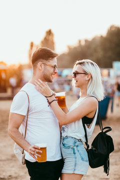 Young couple at the music festival having fun
