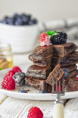 chocolate pancakes with fresh berries, honey and mint