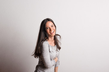Portrait of a young beautiful woman in studio on a white background.