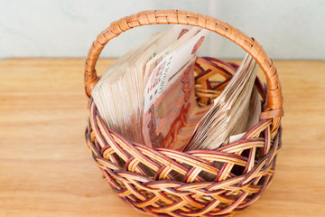 A lot of Russian money in denominations of five thousand rubles are in the basket