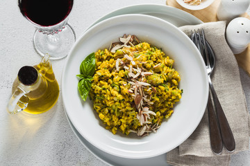 risotto with zucchini and turmeric or saffron in a plate on the table. healthy italian food